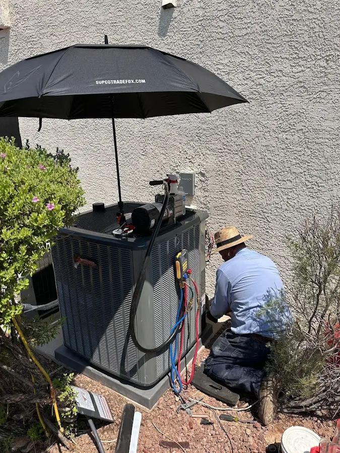 HVAC technician performing outdoor AC maintenance in Folsom
